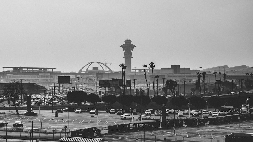Airport control tower and terminals with busy parking lot