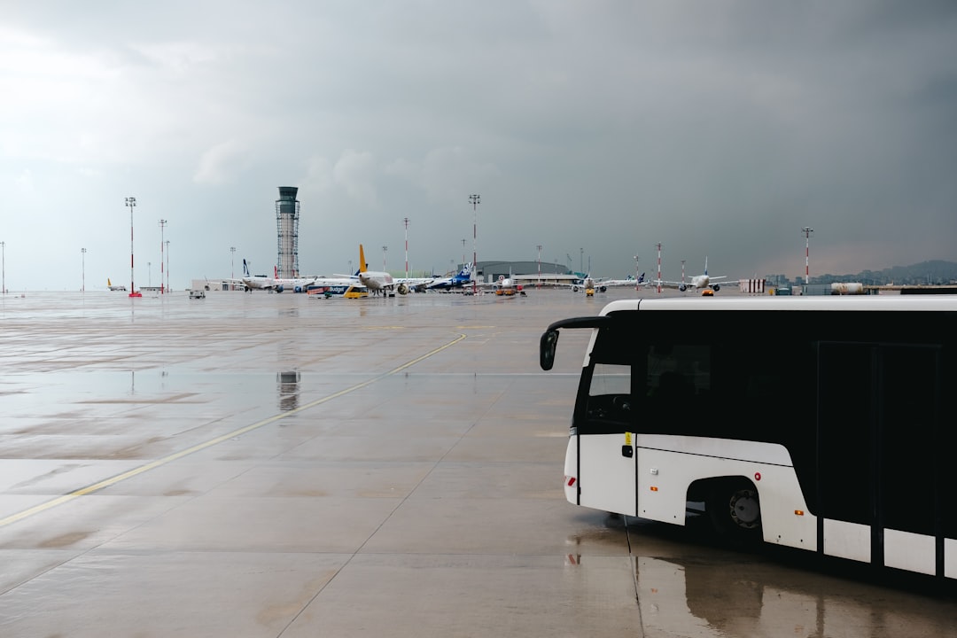 A black and white bus parked in a parking lot