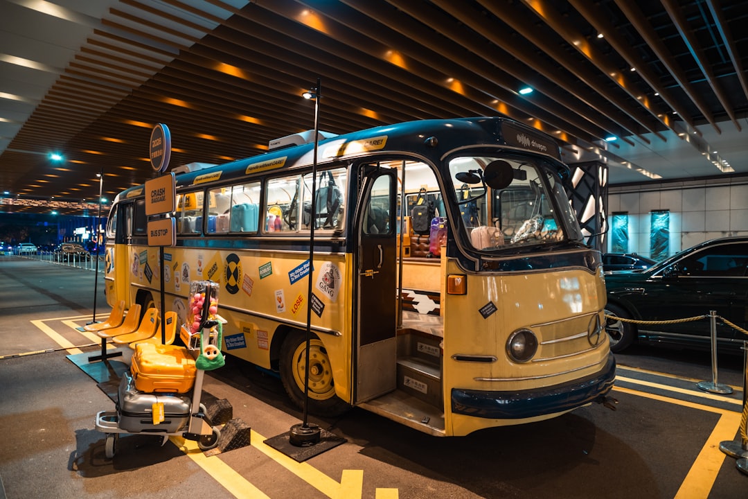 Retro yellow bus decorated with stickers and luggage