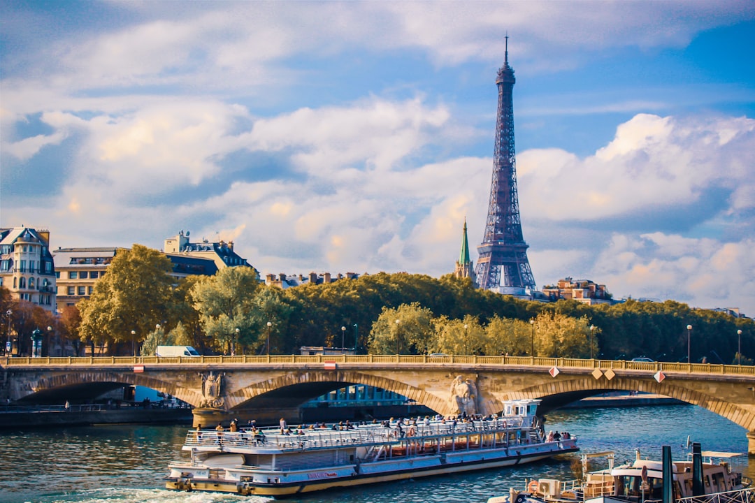 a bridge over a river with a tower in the background