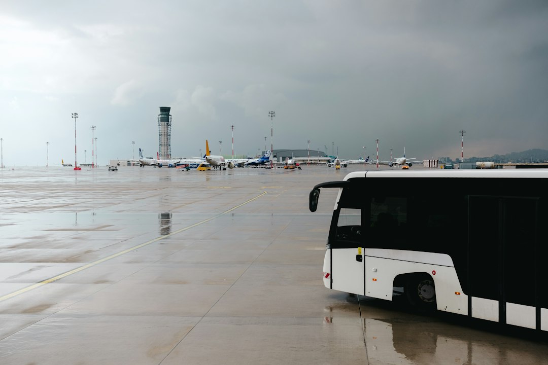 A black and white bus parked in a parking lot